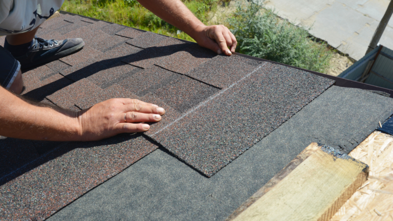 Roof repair service in South Yarra, Victoria, with a roofer installing and aligning asphalt shingles on a residential roof.