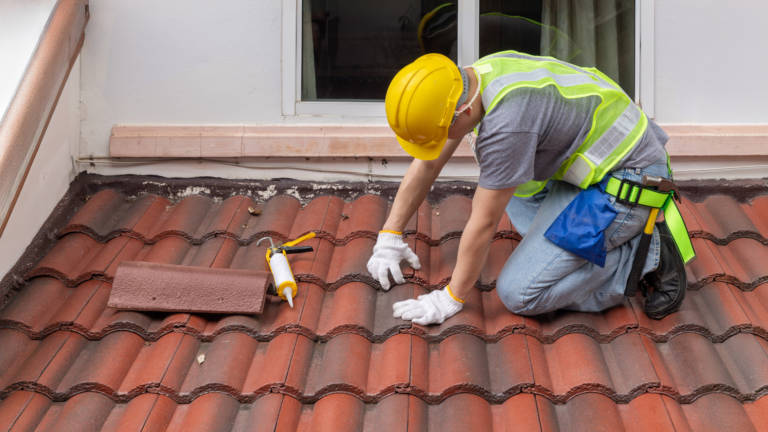 Roof repair service in Caulfield, Melbourne, with a PNK Property Maintenance Solutions tradesperson inspecting and sealing residential roof tiles.
