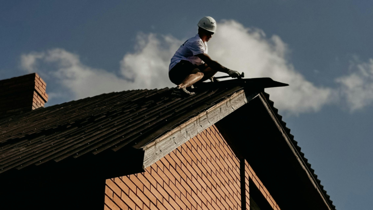 Roof carpentry service in South Melbourne, Victoria, with a PnK Propert Maintenance Solutions tradesperson repairing timber roof components on a residential home.